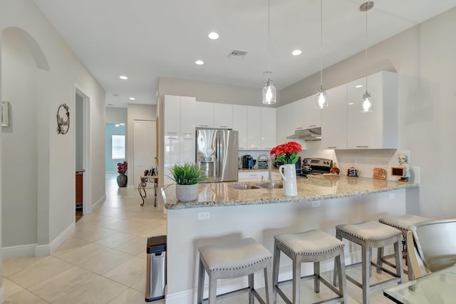 kitchen featuring hanging light fixtures, white cabinetry, appliances with stainless steel finishes, and sink