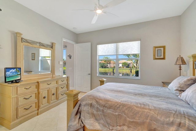 tiled bedroom featuring ceiling fan