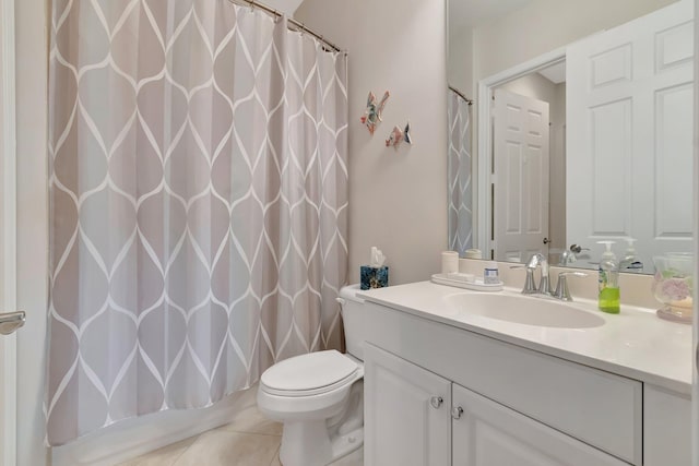 bathroom featuring tile patterned floors, vanity, and toilet