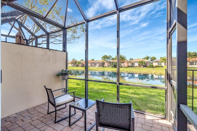 unfurnished sunroom with a water view