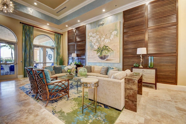 living room with ornamental molding, a towering ceiling, and french doors