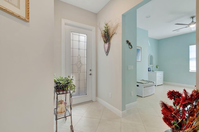 tiled entryway featuring ceiling fan