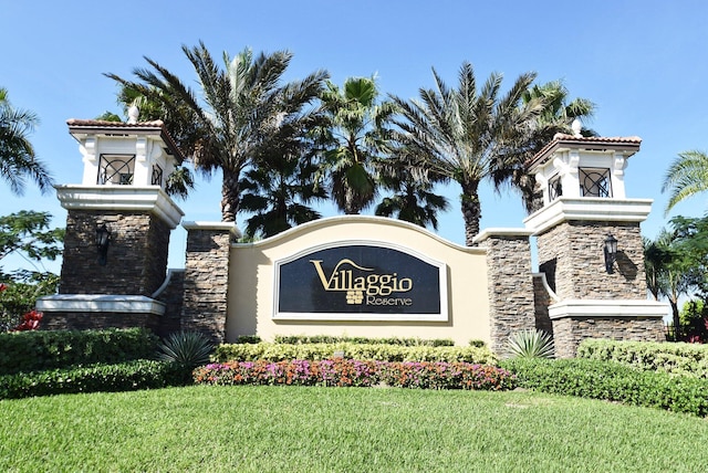 community sign featuring a lawn