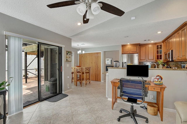 tiled home office featuring lofted ceiling, ceiling fan with notable chandelier, and a textured ceiling