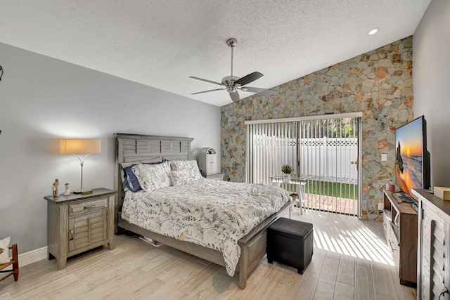 bedroom with lofted ceiling, access to exterior, light hardwood / wood-style floors, and ceiling fan