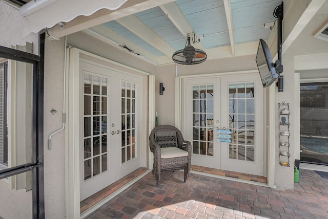 property entrance featuring a patio area, french doors, and ceiling fan