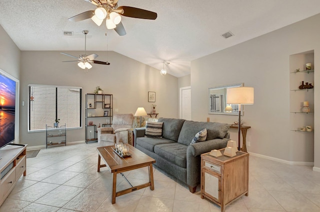 living room with ceiling fan, vaulted ceiling, a textured ceiling, and light tile patterned floors