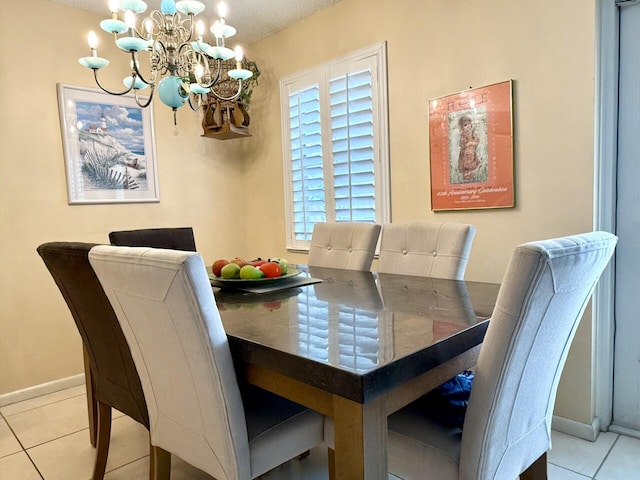 tiled dining space featuring an inviting chandelier