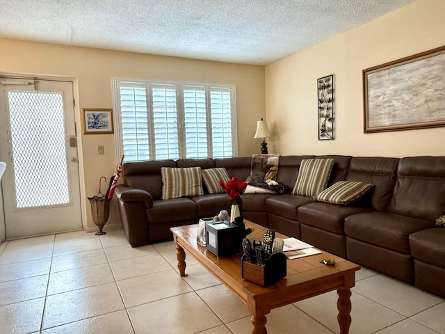 living room with light tile patterned floors and a textured ceiling