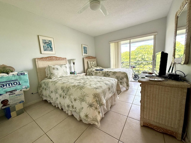 tiled bedroom featuring ceiling fan, access to outside, and a textured ceiling