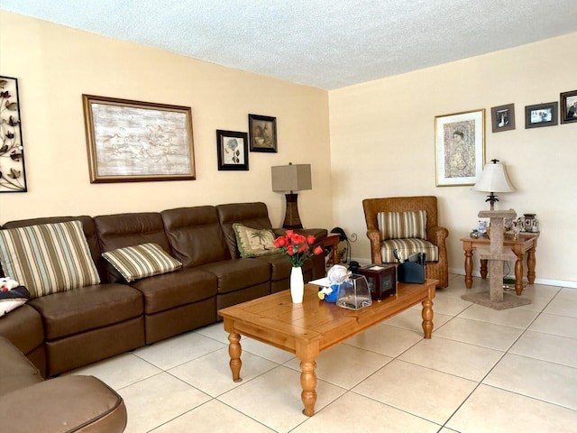 living room with light tile patterned flooring and a textured ceiling