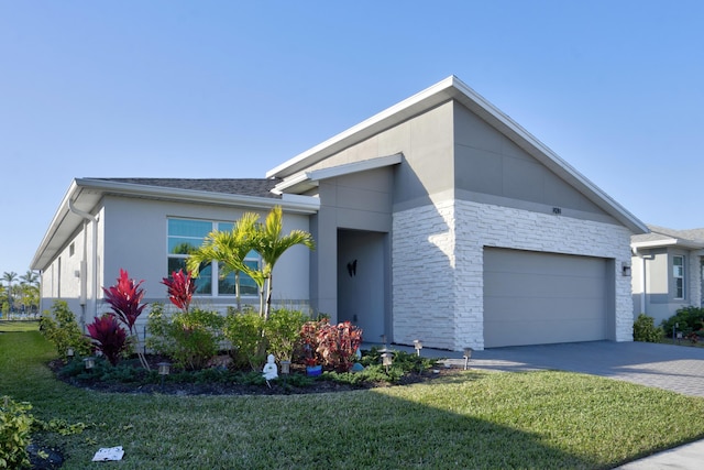 contemporary home with a garage and a front yard