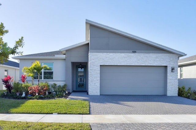 view of front facade with a garage and a front lawn