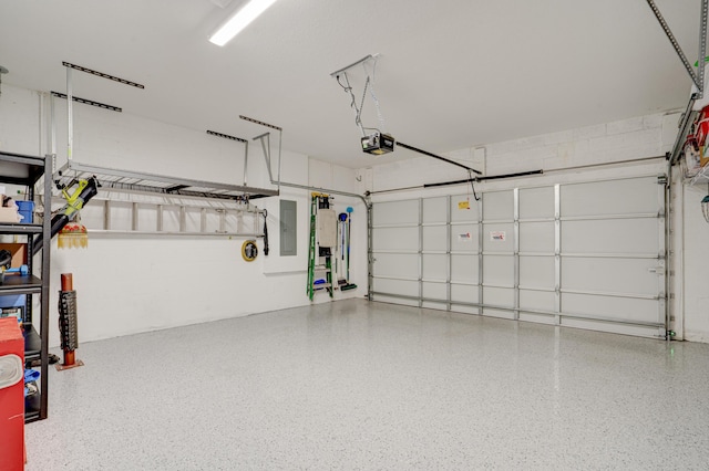 garage with a garage door opener and electric panel