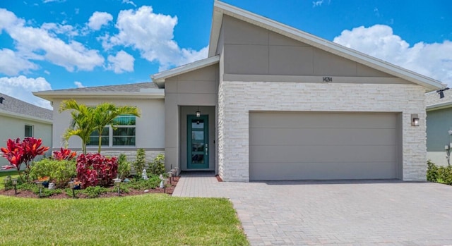 view of front of home featuring a garage and a front lawn