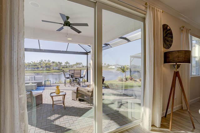 doorway to outside with crown molding, ceiling fan, plenty of natural light, a water view, and light hardwood / wood-style floors