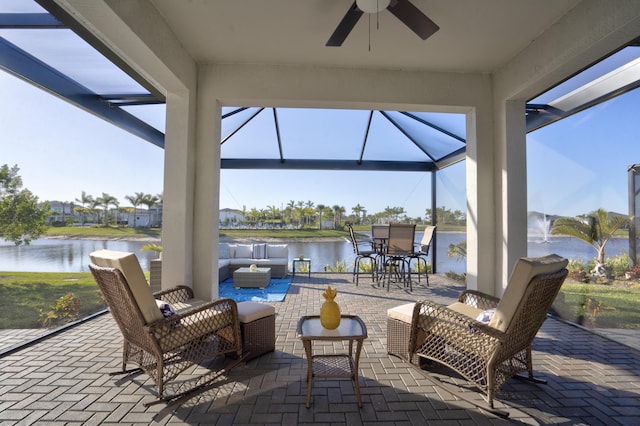 view of patio / terrace with an outdoor living space, ceiling fan, and a water view