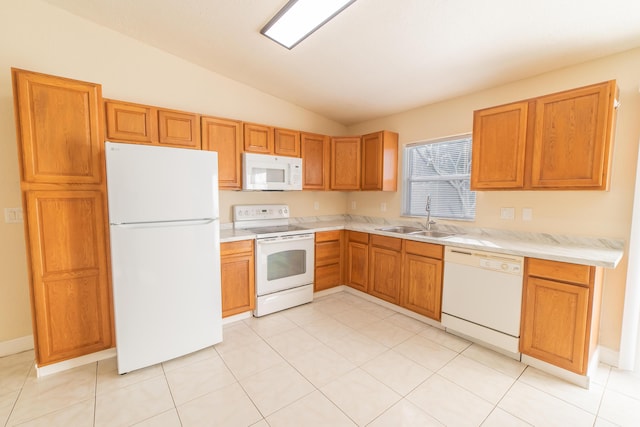 kitchen featuring vaulted ceiling, sink, light tile patterned floors, and white appliances