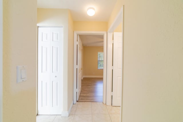 corridor with light tile patterned floors