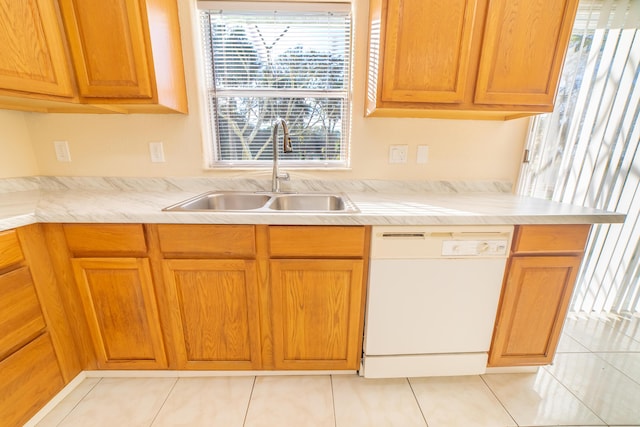 kitchen with dishwasher, sink, and light tile patterned floors