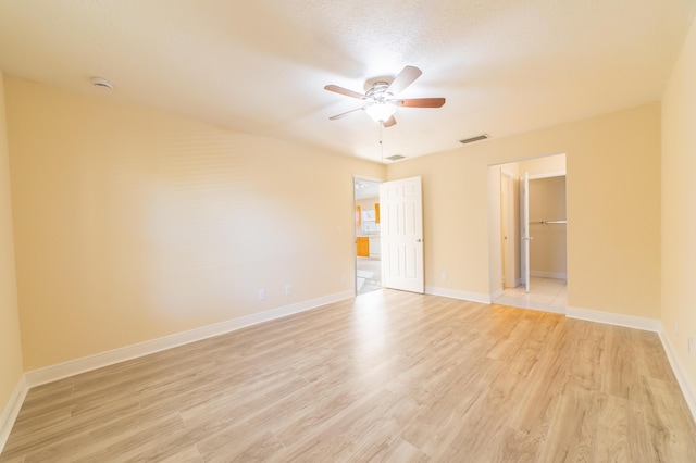 unfurnished room featuring ceiling fan, a textured ceiling, and light hardwood / wood-style floors