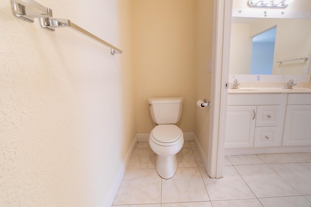 bathroom featuring tile patterned flooring, vanity, and toilet