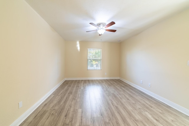 empty room featuring ceiling fan and light hardwood / wood-style flooring