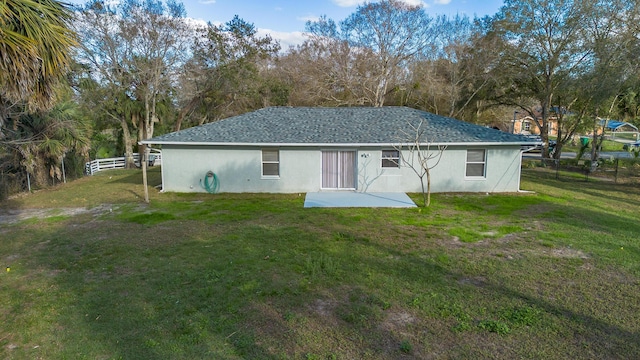 back of house featuring a yard and a patio area