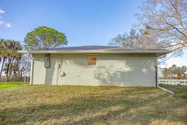 view of side of property with a yard