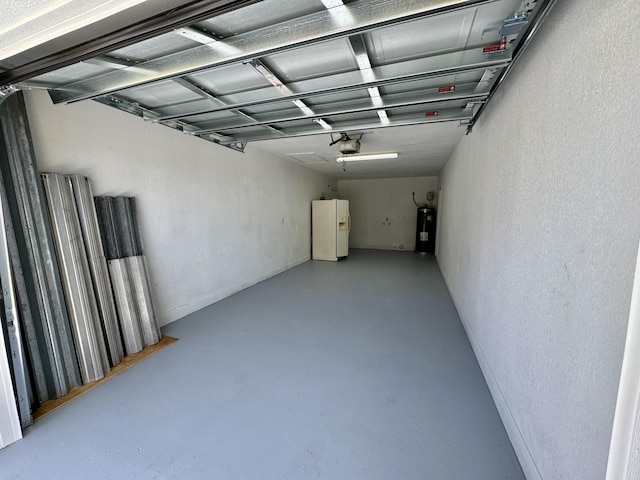 garage with a garage door opener, electric water heater, and white fridge with ice dispenser