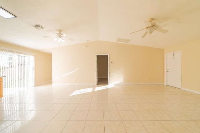 spare room featuring ceiling fan, vaulted ceiling, and light tile patterned floors