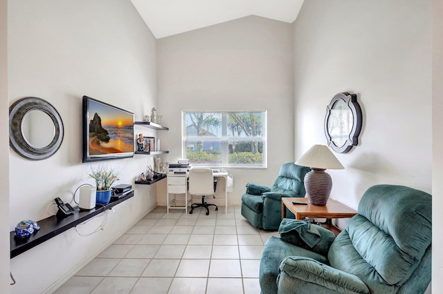 office area with high vaulted ceiling and light tile patterned flooring