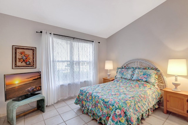 bedroom featuring lofted ceiling and light tile patterned floors