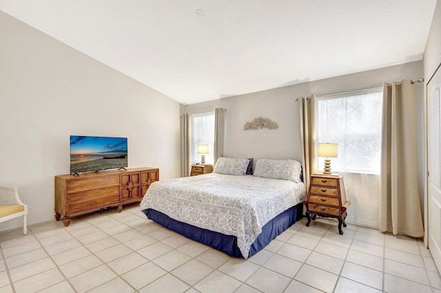 bedroom featuring lofted ceiling and light tile patterned floors