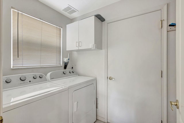 laundry area featuring cabinet space, visible vents, and washer and dryer