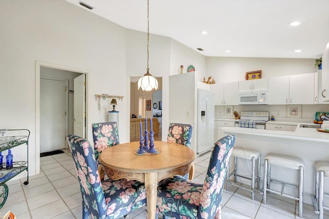 dining space with high vaulted ceiling, recessed lighting, and light tile patterned floors