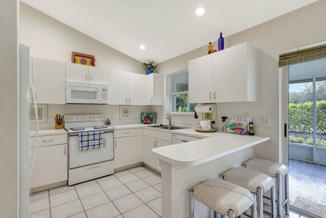 kitchen featuring white appliances, white cabinets, a peninsula, light countertops, and a sink