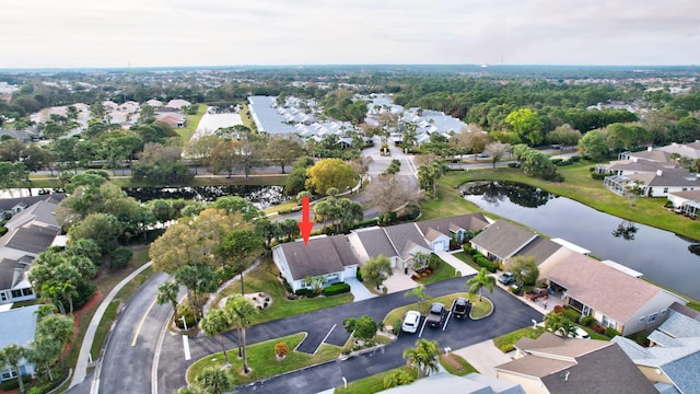 birds eye view of property with a water view and a residential view