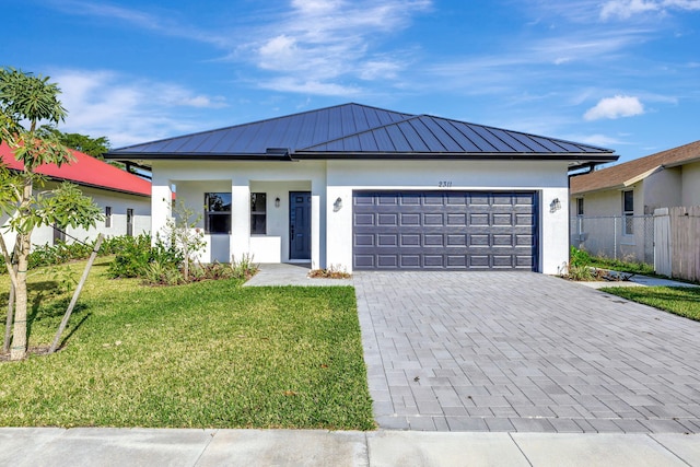 view of front of property with a garage and a front yard