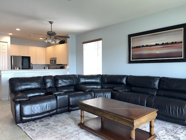 living room featuring light tile patterned flooring and ceiling fan