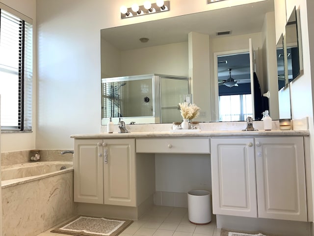 bathroom with tile patterned flooring, plus walk in shower, a healthy amount of sunlight, and vanity