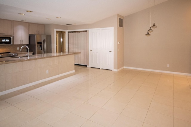 kitchen featuring light tile patterned flooring, sink, pendant lighting, stainless steel appliances, and backsplash