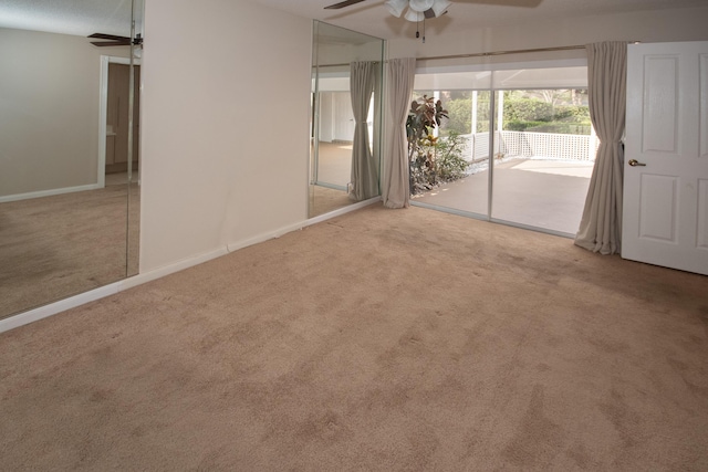 spare room featuring ceiling fan and light carpet