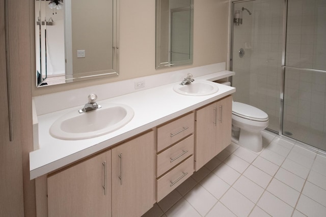 bathroom with vanity, toilet, an enclosed shower, and tile patterned flooring