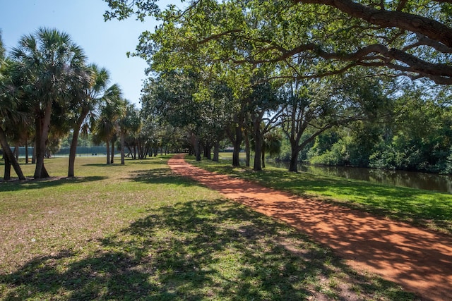 view of property's community featuring a yard and a water view