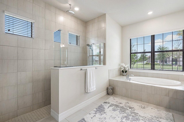 bathroom with tile patterned flooring and a tile shower