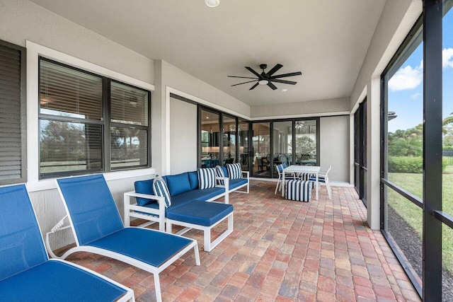 sunroom / solarium featuring ceiling fan