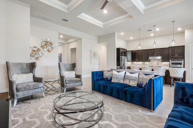 living room featuring beamed ceiling, crown molding, and coffered ceiling