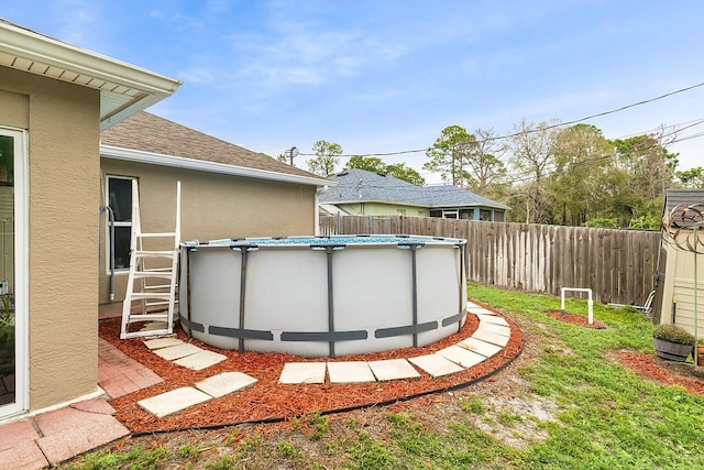 view of yard with a fenced in pool