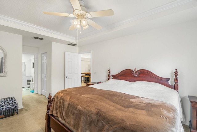 bedroom with crown molding, a tray ceiling, light colored carpet, and ceiling fan